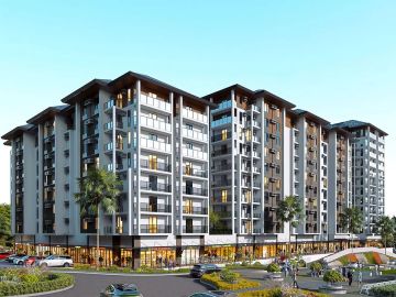 Modern multi-story residential building with greenery.