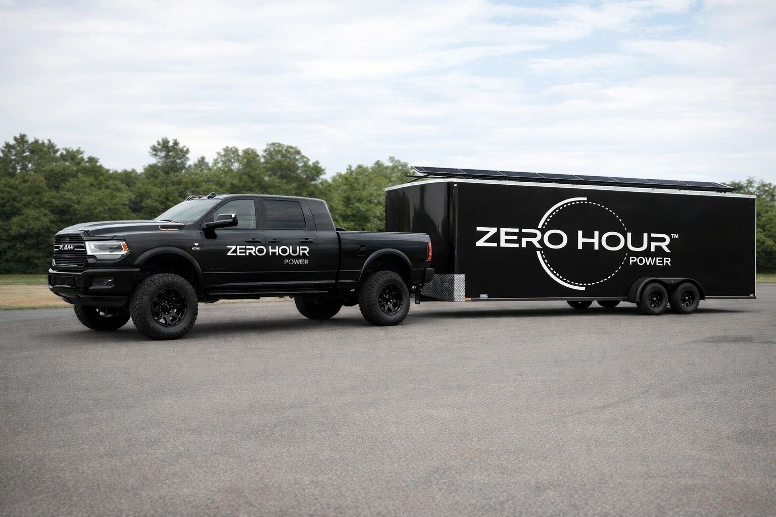 Black RAM truck towing a trailer with Zero Hour Power branding.