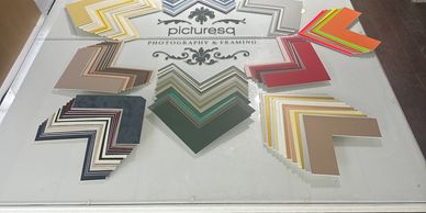 mount matt boards sprayed out over  a display table. great choice of mount board. mounts cut to size