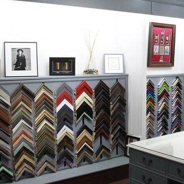 shop interior showing a range of wood mouldings at picturesq framing warrington.