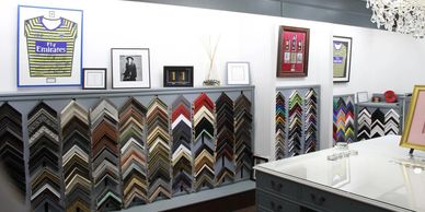 Inside picturesq shop displaying  picture frames for sale. Shop view.