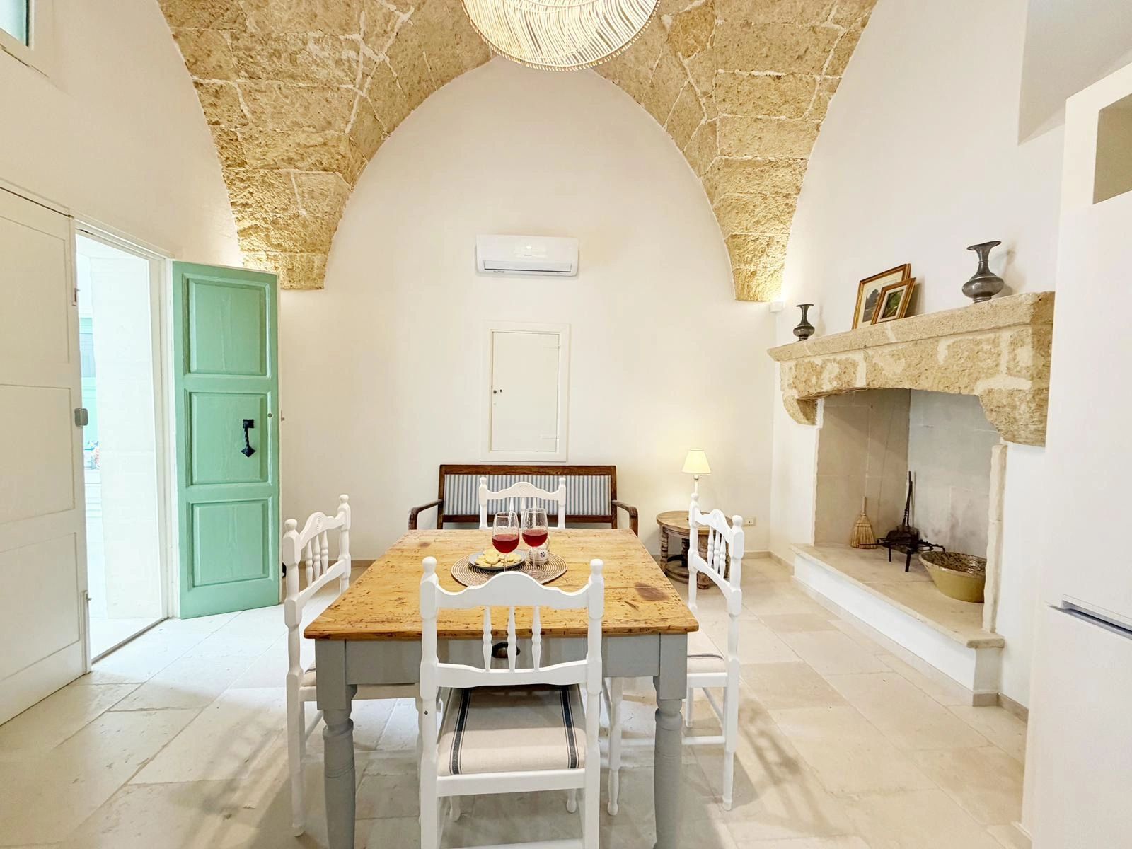 A cozy dining room with rustic charm and stone arch ceiling.