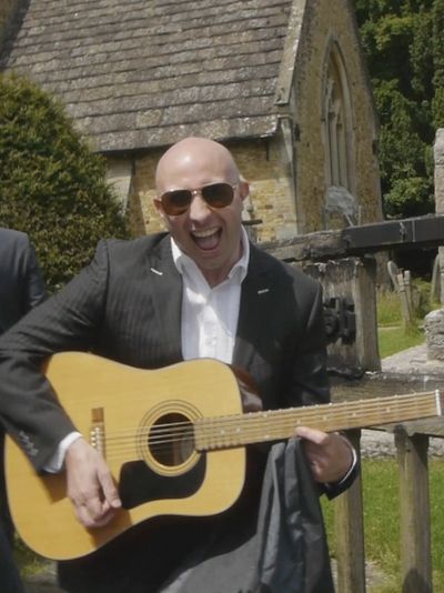 A wedding guest plays guitar