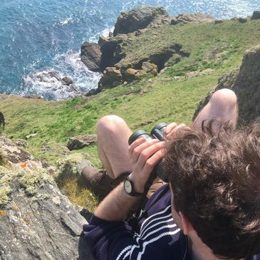 A birder, conducting an ecological survey for EcIA, HRA or similar 