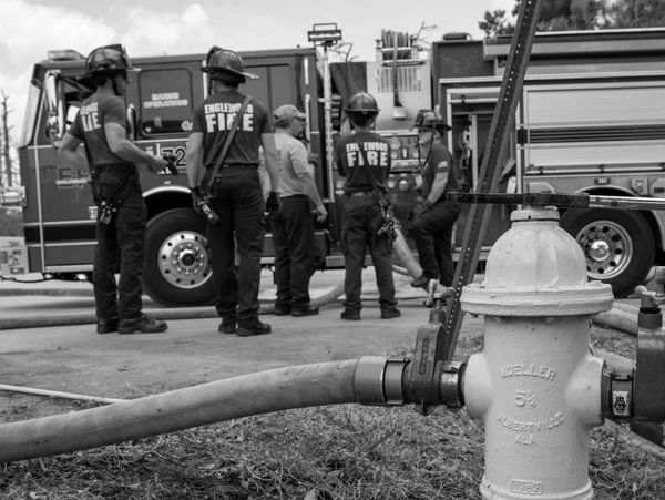 A group of Englewood Fire Department firefighters standing in front of a fire engine.