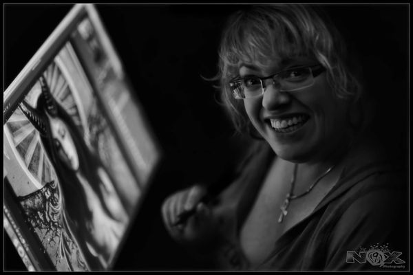 Cindy A Joubert-Kelly working at her Wacom Cintiq art station. Photo credit to Nikki Nox (Nicole Jou