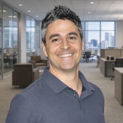 Smiling man in a modern office setting.