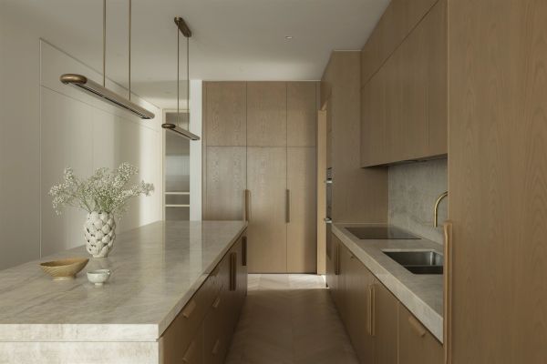 Manhattan Residence kitchen in Toorak with timber joinery and stone island. Photography: Dylan James