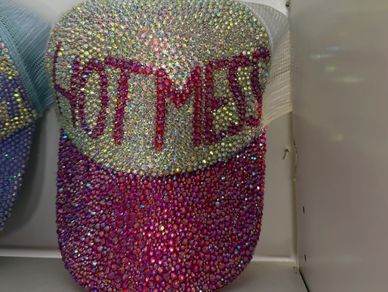Beautifully customized rhinestone hat that says “Hot Mess”