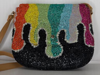 Beautifully customized rhinestone purse with rainbow stones dripping down onto a black base