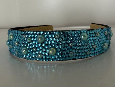 Beautifully customized headband with blue rhinestones and teal pearls!