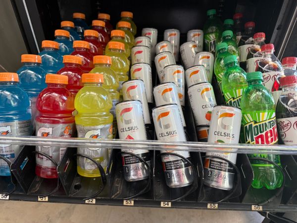 Various beverages arranged in a vending machine.