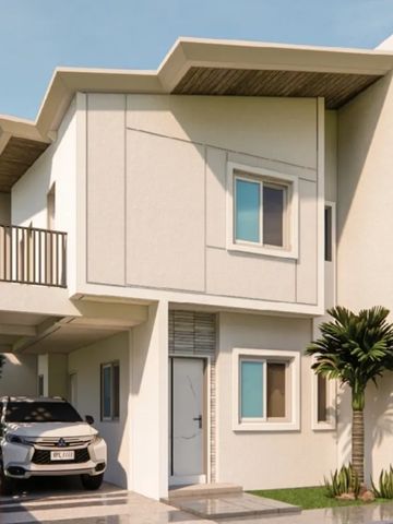 Modern two-story house with a car parked in the driveway and a palm tree beside the entrance.