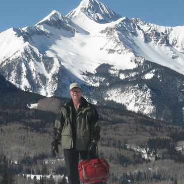 Asbestos, Lead, and Mold inspector snowshoeing to a project near the San Juan Mountains.
