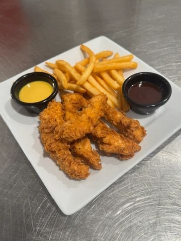 Five crispy breaded chicken strips and a side of fries and dipping sauces on a white plate. 
