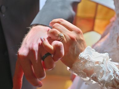 A bride and groom's pinky promise to show off their new wedding rings after their wedding ceremony