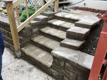 Stone stairs with side seating under construction.