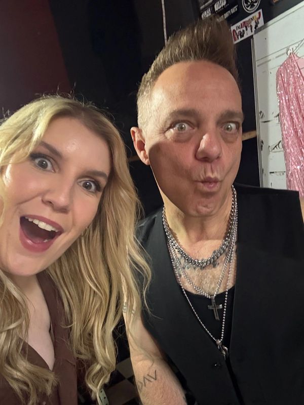 Two people making playful faces in a close-up selfie.