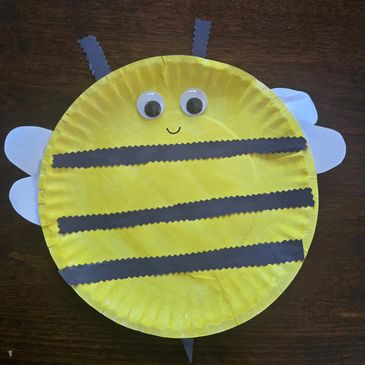 Crafted paper plate bee with googly eyes and wings.