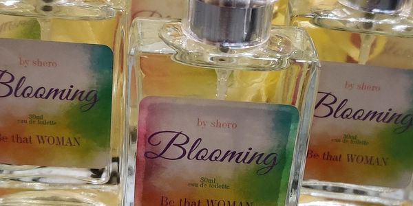 Clear 30ml glass fragrance bottle inside of a yellow mesh gift bag. 