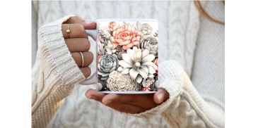Person holding a floral-decorated white cup.