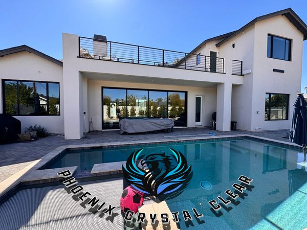Modern backyard with swimming pool and patio area.