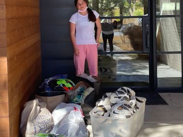 Savannah donating several boxes of soccer items to 2ndChanceCleats