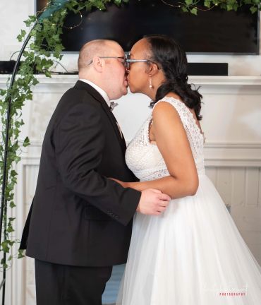 Bride and groom sharing a kiss at their wedding.