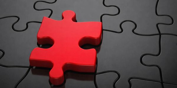 Obsidian red puzzle piece sitting on top of flat puzzle.
