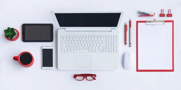 Clean white background with laptop and office supplies