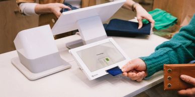 Person makes payment using card at a digital terminal.