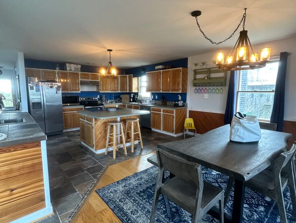 Cozy kitchen and dining area with wooden cabinets and rustic lighting.