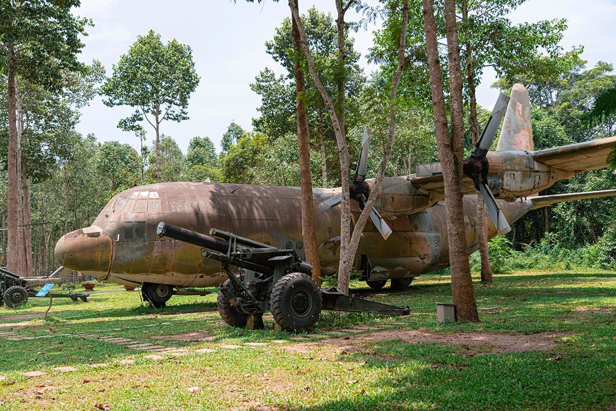 Historic military aircraft on display surrounded by tropical greenery – a sobering war history site in this Ho Chi Minh City guide
