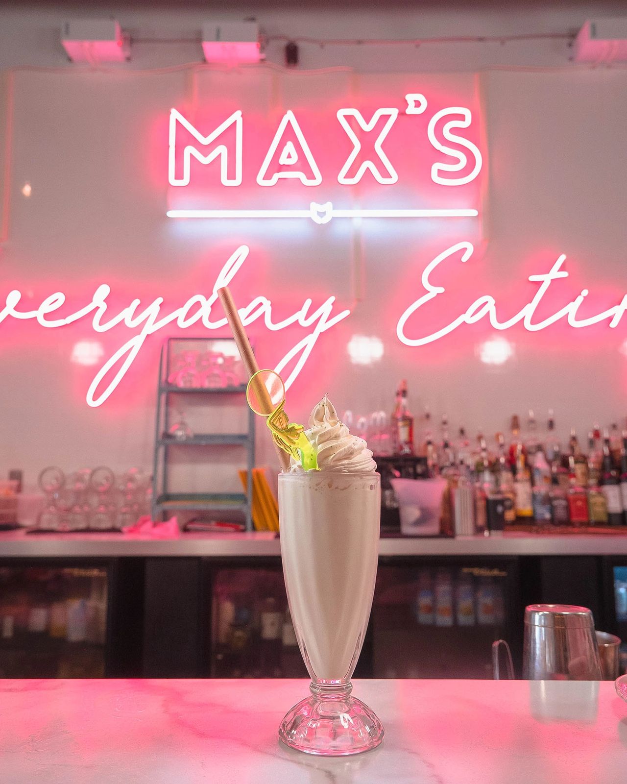 Step into Max’s Eatery in Lancaster, PA, where neon lights, retro aesthetics, and delicious comfort food create the ultimate dining experience. This creamy vanilla milkshake, topped with whipped cream and a fun twist, perfectly captures the playful and nostalgic energy of this local favorite. Whether you're craving diner-style eats, creative cocktails, or sweet treats, Max’s Eatery delivers a modern take on everyday eating with a fun and vibrant atmosphere.