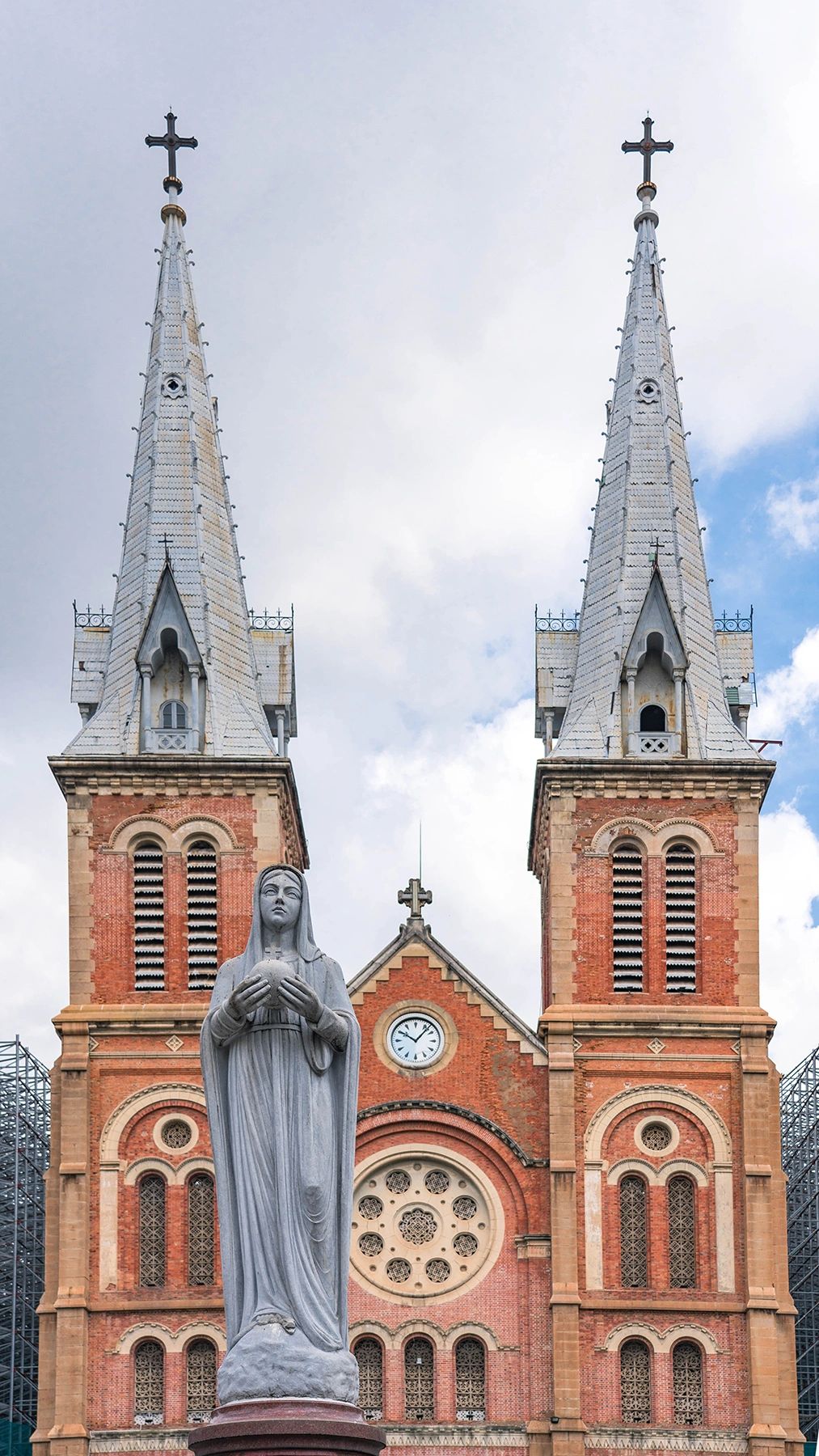 Twin spires of Notre Dame Cathedral of Saigon with Virgin Mary statue – stunning French colonial architecture in this Ho Chi Minh City guide
