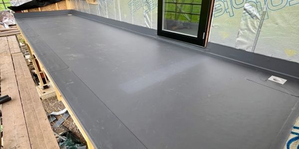 Newly installed flat roof with a door leading outside.