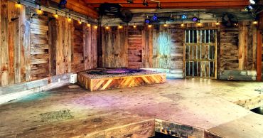 Empty wooden stage with colorful lighting.