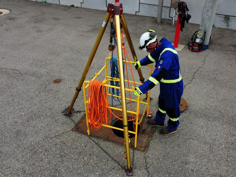 Rescuer attending a confined space ready to rescue if needed.