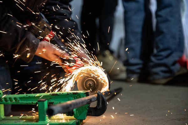 A technician making routine cuts, repair, and inspection of a heating and cooling gas pipe.