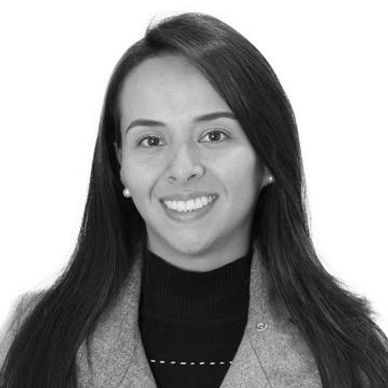 Professional black and white portrait of a smiling woman with long hair.