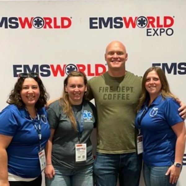 Ashten, Kylie, and Jen meeting EMS World Expo speaker from the Fire Department Chronicles 