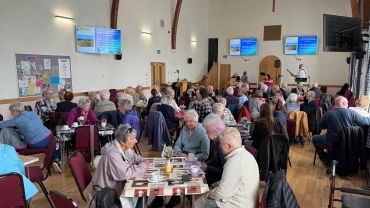 Community event with seniors dining together.