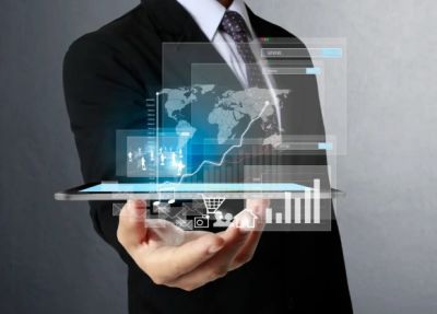 Businessman holding tablet with holographic data projections.