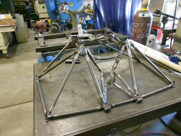 Metal frame structure on a workshop table.