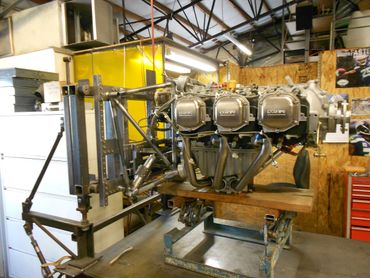 A complex mechanical engine setup in a workshop.