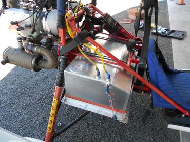 Close-up of a small aircraft's engine and fuel system components.