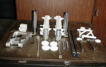 Various mechanical parts neatly arranged on a table.