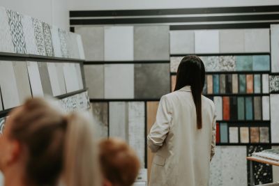 Woman browsing tiles in a showroom.