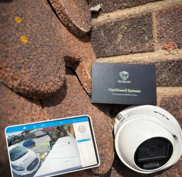 Security camera setup with a tablet showing live footage on a roof.