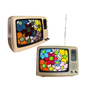 Two vintage TVs with floral stained glass screens.